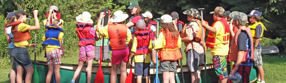 School glass in life vests taking in a canoeing lesson