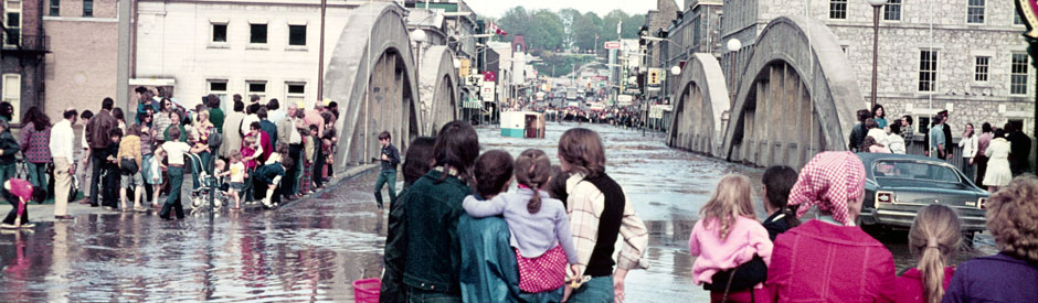 Flood of 1974, downtown Galt (cambridge) with crowd of people (Main Street Bridge)