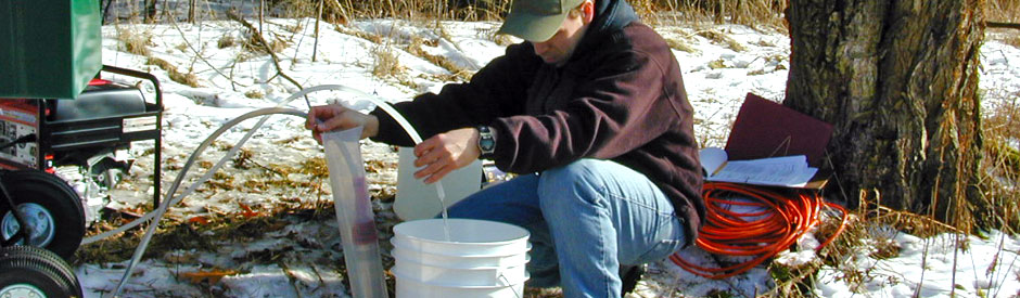 Staff using equipment to take groundwater samples
