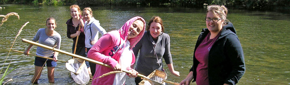 High school students in the river with dipnets