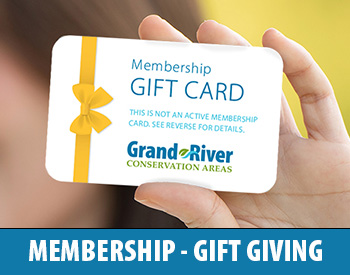 Hand holding a membership gift card 